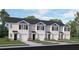 New townhome exteriors showing the modern white siding, black shutters, and single car garage at 549 Stream Walk Xing, Wendell, NC 27591