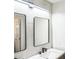 Modern bathroom with sleek, updated vanity, sink, lighting and large, framed mirror at 5505 Pennfine Dr, Raleigh, NC 27610