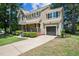 Traditional home with attached garage, manicured landscaping and a cozy covered porch at 5505 Pennfine Dr, Raleigh, NC 27610