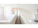 Upstairs hallway with hardwood floors and natural light at 5505 Pennfine Dr, Raleigh, NC 27610
