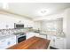Open concept kitchen with granite countertops, stainless steel appliances, and wooden island at 5505 Pennfine Dr, Raleigh, NC 27610