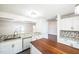 Bright kitchen featuring white cabinets, granite countertops, and a convenient center island at 5505 Pennfine Dr, Raleigh, NC 27610