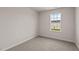 Bright bedroom with neutral carpet and trim, naturally illuminated by a single window at 552 Stream Walk Xing, Wendell, NC 27591