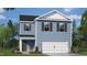 Charming two-story home with blue siding, white trim, and a two-car garage, complemented by a landscaped front yard at 552 Stream Walk Xing, Wendell, NC 27591