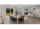 Eat-in kitchen with grey cabinetry, granite countertops, stainless steel appliances, and sliding glass doors to the backyard at 552 Stream Walk Xing, Wendell, NC 27591