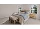 Inviting main bedroom featuring a comfortable bed with neutral tones, complemented by windows with serene outdoor views at 552 Stream Walk Xing, Wendell, NC 27591