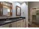 Bathroom features double vanity with granite countertops, framed mirrors and walk-in closet at 5638 Wade Park Blvd, Raleigh, NC 27607