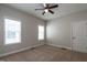 Bedroom with neutral walls, ceiling fan, carpeted floors, and bright windows at 5638 Wade Park Blvd, Raleigh, NC 27607