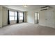 A spacious carpeted bedroom with two bright windows, light walls, and climate control system at 5638 Wade Park Blvd, Raleigh, NC 27607