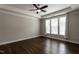 Bedroom with hardwood floors, large windows, tray ceiling, and neutral wall color at 5638 Wade Park Blvd, Raleigh, NC 27607