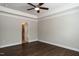 Neutral bedroom featuring a ceiling fan, tray ceiling, hardwood floors and entry to the bathroom at 5638 Wade Park Blvd, Raleigh, NC 27607