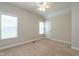 Bedroom with neutral walls, ceiling fan, carpeted floors, and bright windows at 5638 Wade Park Blvd, Raleigh, NC 27607