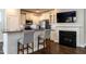 Modern kitchen bar featuring grey bar stools, granite countertops, and stainless steel appliances at 5638 Wade Park Blvd, Raleigh, NC 27607
