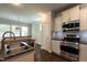 Modern kitchen with stainless steel appliances, granite counters, and a convenient breakfast bar at 5638 Wade Park Blvd, Raleigh, NC 27607