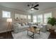 Inviting living room filled with natural light, featuring a comfortable sectional, stylish decor, and ceiling fan at 5638 Wade Park Blvd, Raleigh, NC 27607