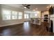 Bright, open living room with hardwood floors, modern lighting, and bar seating near a modern kitchen at 5638 Wade Park Blvd, Raleigh, NC 27607