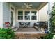 Inviting front porch with outdoor seating, ceiling fan, and decorative plants at 5638 Wade Park Blvd, Raleigh, NC 27607