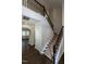 Staircase features wood and metal railings with carpeted treads and wood floors in the entry at 5638 Wade Park Blvd, Raleigh, NC 27607