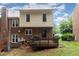 Backyard view of two-story home with a deck and a mix of brick and siding at 6225 Waterside Ln, Raleigh, NC 27613