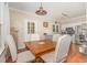 Cozy dining area featuring a wooden table and an adjacent kitchen, perfect for Gathering meals and entertaining at 6225 Waterside Ln, Raleigh, NC 27613