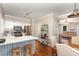 Eat-in kitchen with white cabinets, stainless steel appliances, and a view into the dining and living areas at 6225 Waterside Ln, Raleigh, NC 27613