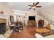Open-concept living room with hardwood floors and seamless flow to the dining area, ideal for modern living at 6225 Waterside Ln, Raleigh, NC 27613