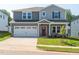 Charming two-story home featuring a two-car garage, covered porch, and well-manicured lawn at 713 Deschutes Dr, Garner, NC 27529