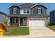 Charming two-story home with a well-manicured lawn and a two car garage at 716 Deschutes Dr, Garner, NC 27529