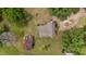 Aerial view of the property showing the house, barn, trees and the surrounding countryside at 7404 Halifax Rd, Youngsville, NC 27596