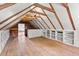 Spacious attic area with wood flooring, exposed beams, built in shelving and natural light at 7404 Halifax Rd, Youngsville, NC 27596