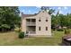 Exterior view showcasing the two-story layout, stone chimney, and well-kept lawn at 7404 Halifax Rd, Youngsville, NC 27596
