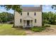 Charming two-story historic home featuring a welcoming front porch and well-maintained landscaping at 7404 Halifax Rd, Youngsville, NC 27596