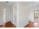 Hallway with hardwood floors, white wainscoting and access to the bathroom and other rooms at 7404 Halifax Rd, Youngsville, NC 27596
