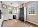Spacious kitchen with white cabinetry, black appliances, and a large refrigerator at 7404 Halifax Rd, Youngsville, NC 27596