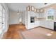 Open kitchen featuring white cabinetry, hardwood floors and lots of light at 7404 Halifax Rd, Youngsville, NC 27596