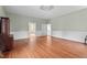 Living room features hardwood floors and recessed paneling leading to other rooms at 7404 Halifax Rd, Youngsville, NC 27596