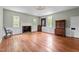 Spacious living room featuring hardwood floors, recessed paneling and a fireplace at 7404 Halifax Rd, Youngsville, NC 27596