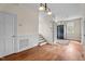 Hardwood floors and recessed paneling in the living room add architectural interest to the home at 7404 Halifax Rd, Youngsville, NC 27596