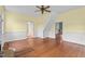Living room features hardwood floors, recessed paneling, and an abundance of natural light at 7404 Halifax Rd, Youngsville, NC 27596