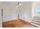 Living room featuring recessed paneling, hardwood floors and a view of the stairway at 7404 Halifax Rd, Youngsville, NC 27596