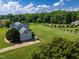 Aerial view of a beautiful home, a large lot, and mature trees at 80 Shambley Meadows Dr, Pittsboro, NC 27312