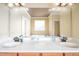 Bright bathroom featuring a double sink vanity, soaking tub, and tiled surround at 80 Shambley Meadows Dr, Pittsboro, NC 27312