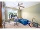 Comfortable carpeted bedroom featuring a ceiling fan, a large window, and olive green walls at 80 Shambley Meadows Dr, Pittsboro, NC 27312
