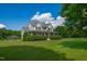 Beautiful two-story home featuring a wraparound porch, lush greenery, and a well-manicured lawn at 80 Shambley Meadows Dr, Pittsboro, NC 27312