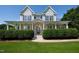 Charming two-story home boasts a welcoming front porch, well-manicured hedges, and lush landscaping at 80 Shambley Meadows Dr, Pittsboro, NC 27312