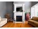 Living room featuring a marble fireplace with flatscreen and warm decorative furnishings at 80 Shambley Meadows Dr, Pittsboro, NC 27312
