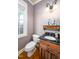 Cozy half bath featuring hardwood floors, a black countertop, and framed wall art at 80 Shambley Meadows Dr, Pittsboro, NC 27312