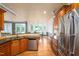 This gourmet kitchen features stainless steel appliances, a stone backsplash, and an open layout to the dining area at 80 Shambley Meadows Dr, Pittsboro, NC 27312