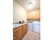 Well-organized laundry room with sink, cabinets, countertop space, and washer/dryer at 80 Shambley Meadows Dr, Pittsboro, NC 27312