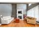 Cozy living room boasting a fireplace, large windows, and comfortable seating, perfect for relaxing at 80 Shambley Meadows Dr, Pittsboro, NC 27312